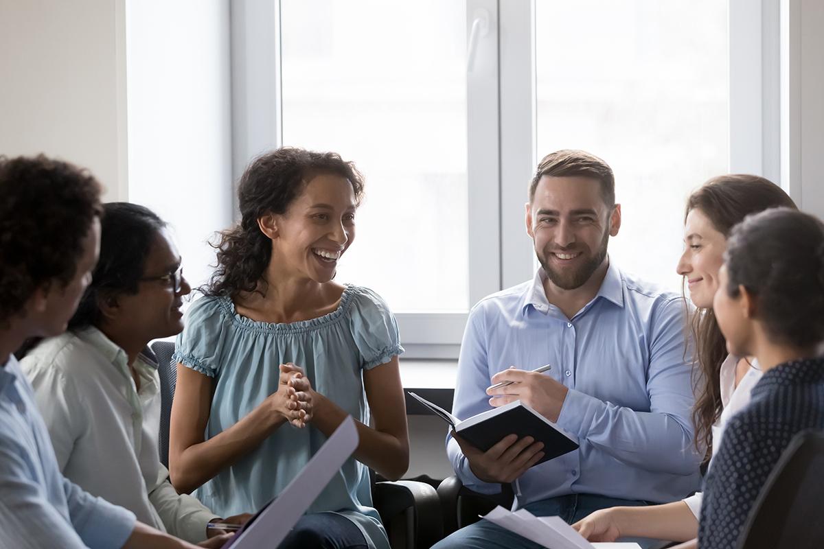 Yusen Logistics employees smiling and engaged during a team meeting, reflecting a positive and collaborative work environment
